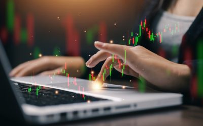 Stock,Market,Trading,Chart,Hologram,Above,Laptop,With,Businesswoman,Analyzing
